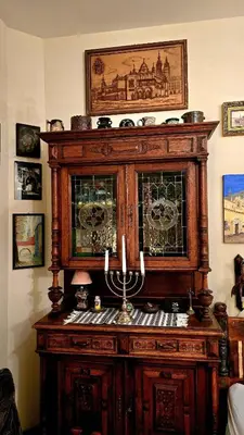 a large wooden cabinet with a organ in a room at ATELIER Kazimierz in Kraków