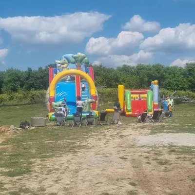 a group of people sitting in chairs at a playground at Uszate Ranczo in Rybna