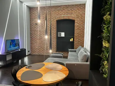 a living room with a table and a couch at Vintage Bracka Loft Apartment in Kraków