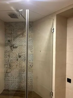 a shower with a glass door in a bathroom at Vintage Bracka Loft Apartment in Kraków