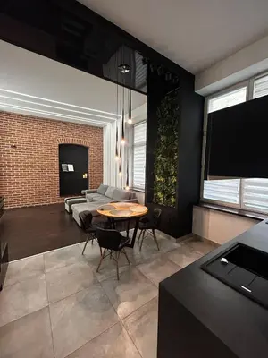 a living room with a table and a couch at Vintage Bracka Loft Apartment in Kraków