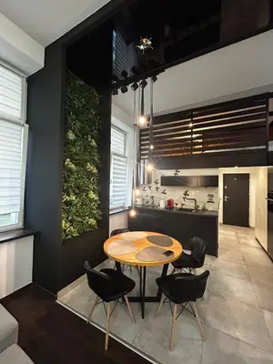 a kitchen and dining room with a table and chairs at Vintage Bracka Loft Apartment in Kraków