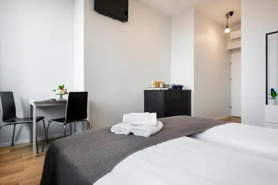 a bedroom with a bed with two towels on it at Krakow B&B in Kraków