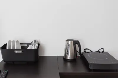 a desk with a coffee maker and a tea kettle at Krakow B&B in Kraków