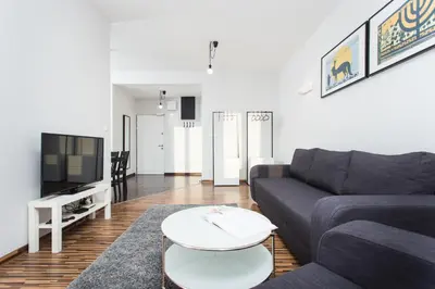 a living room with a couch and a table at Krakow B&B in Kraków