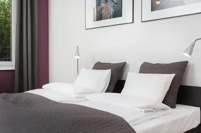 a bedroom with a bed with white and gray pillows at Krakow B&B in Kraków