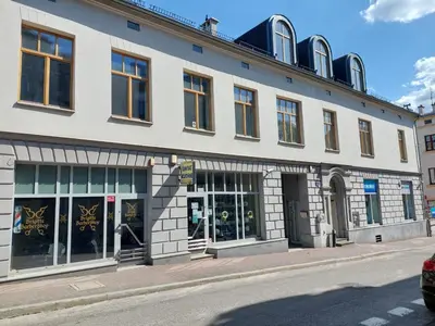 a large white building with windows on a street at Atelier Stare Miasto in Chrzanów