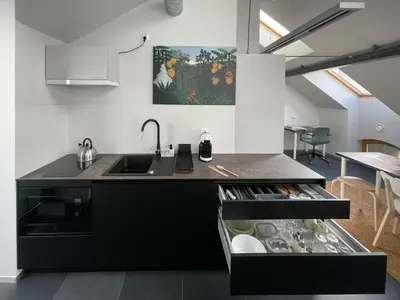 a kitchen with a sink and a counter at Atelier Stare Miasto in Chrzanów