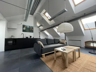 a living room with a couch and a table at Atelier Stare Miasto in Chrzanów