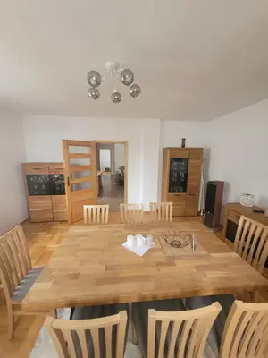 a dining room with a wooden table and chairs at Domek obok pustyni