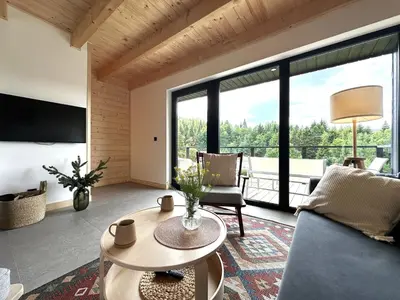 a living room with a couch and a table at BeskiDom in Zawoja