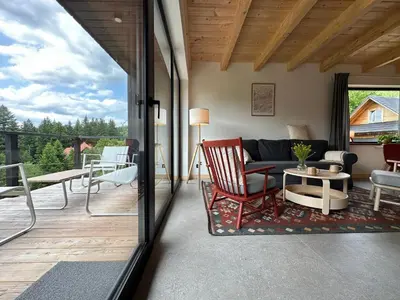 a living room with a couch and a table at BeskiDom in Zawoja