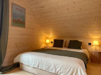 a bedroom with two beds in a log cabin at BeskiDom in Zawoja