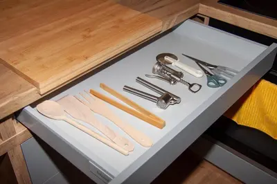 a white table with wooden utensils on it at Apartament Bonarka in Kraków