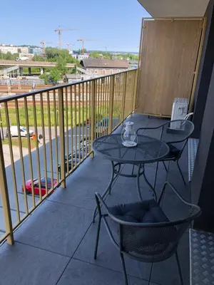 a patio with a table and chairs on a balcony at Apartament Bonarka in Kraków