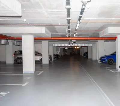 a parking garage with cars parked in it at Apartament Bonarka in Kraków