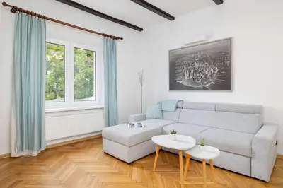 a living room with a couch and a table at Prusa Stylish Apartment Close to the Center of Cracow by Noclegi Renters in Kraków
