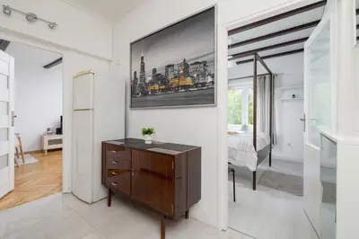 a room with a dresser and a picture on the wall at Prusa Stylish Apartment Close to the Center of Cracow by Noclegi Renters in Kraków