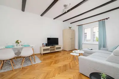 a living room with a couch and a table at Prusa Stylish Apartment Close to the Center of Cracow by Noclegi Renters in Kraków