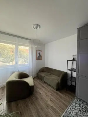 a living room with a couch and a chair at VINCI apartment in Kraków