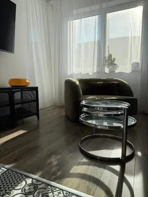 a living room with a couch and a glass table at VINCI apartment in Kraków