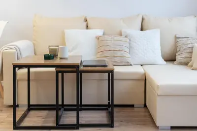 a coffee table next to a couch with pillows at Osiedle Kazimierzowskie in Kraków