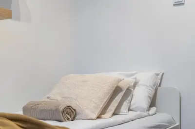 a pile of pillows on a white couch at Osiedle Kazimierzowskie in Kraków