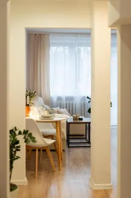 a room with a table and a dining room with a table and chairs at Osiedle Kazimierzowskie in Kraków
