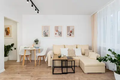 a living room with a couch and a table at Osiedle Kazimierzowskie in Kraków