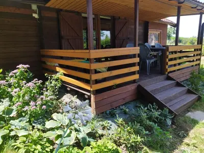 a wooden cabin with a porch and a table at Lavender Retreat in Kraków
