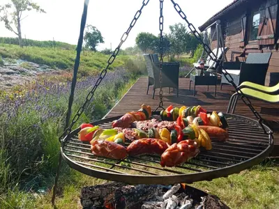 a grill with hot dogs and peppers on it at Lavender Retreat in Kraków