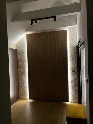 a large wooden door in a room with a wooden floor at Apartamenty Rubikon in Kraków