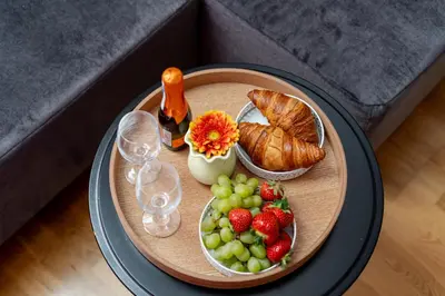 a table topped with fruit and croissants and bread at Malila Premium Apartments Cracow Prażmowskiego 46 in Kraków