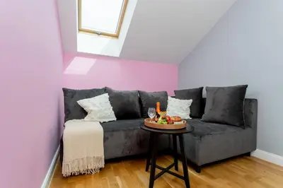 a living room with a gray couch and a table at Malila Premium Apartments Cracow Prażmowskiego 46 in Kraków