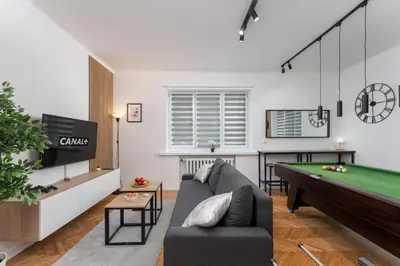 a living room with a couch and a pool table at Zabłocie Comfort House with parking and garden in Kraków