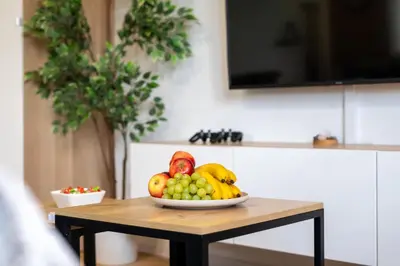 a bowl of fruit on a table in a kitchen at Zabłocie Comfort House with parking and garden in Kraków