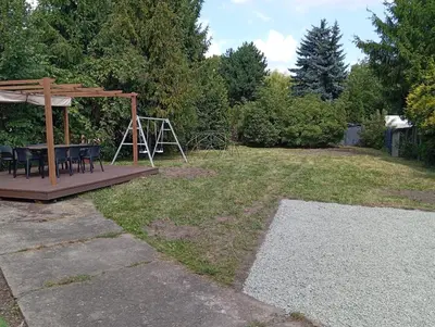 a wooden deck with a picnic table and a gazebo at Zabłocie Comfort House with parking and garden in Kraków