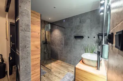 a bathroom with a sink and a shower at Golden Apartment by Cracovia Prime in Kraków