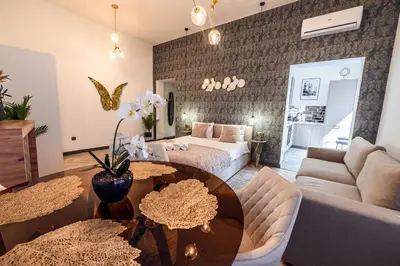 a living room with a bed and a table at Golden Apartment by Cracovia Prime in Kraków