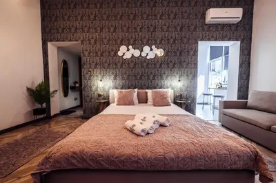 a bedroom with a large bed and a couch at Golden Apartment by Cracovia Prime in Kraków