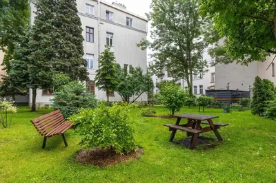 a park with a wooden bench and a picnic table at Starowiślna Cozy Studio in Downtown Cracow by Noclegi Renters in Kraków