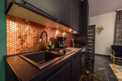 a kitchen with a sink and a counter at Copper Apartment by Cracovia Prime in Kraków