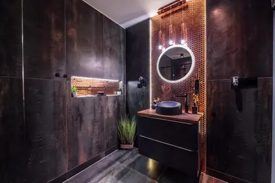 a bathroom with a sink and a mirror at Copper Apartment by Cracovia Prime in Kraków
