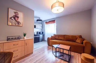 a living room with a couch and a table at Honey Apartment by Cracovia Prime in Kraków