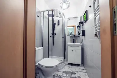 a bathroom with a toilet and a shower and a sink at Honey Apartment by Cracovia Prime in Kraków