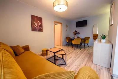 a living room with a couch and a table at Honey Apartment by Cracovia Prime in Kraków