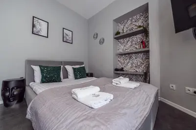 two beds with towels on them in a bedroom at Loc8 Apartments by Cracovia Prime in Kraków