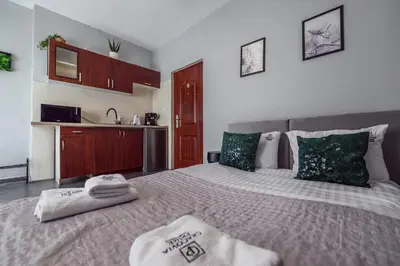 a bedroom with a large bed with towels on it at Loc8 Apartments by Cracovia Prime in Kraków