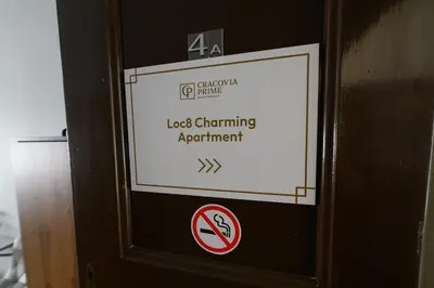 a sign on the side of a door with a no smoking sign at Loc8 Apartments by Cracovia Prime in Kraków
