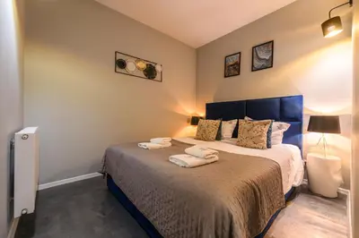 a bedroom with a bed with two towels on it at Loc8 Apartments by Cracovia Prime in Kraków